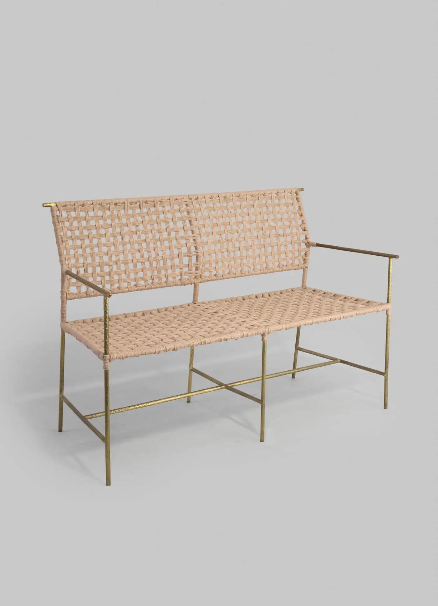 Woven bench with brass frame on a gray background
