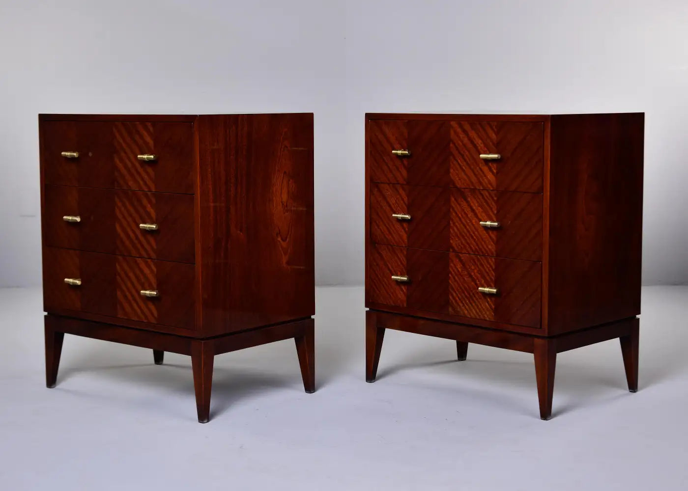 Two wooden dressers with a chevron pattern on a white background