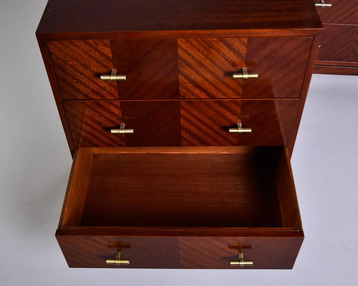 Wooden dresser with open drawer on a white background