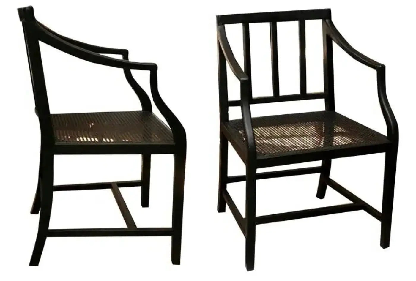 Two black chairs with woven seats on a white background
