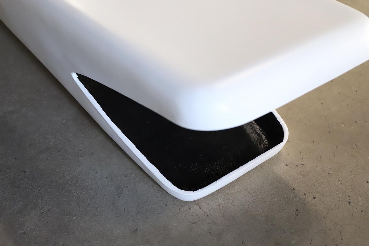 White electronic device with a black screen on a gray surface