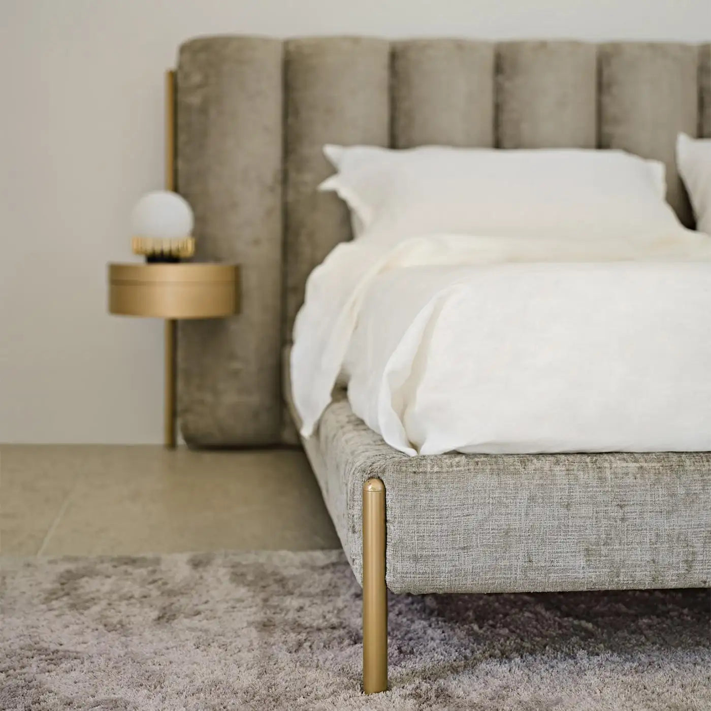 Beige upholstered bed with white bedding in a bedroom setting