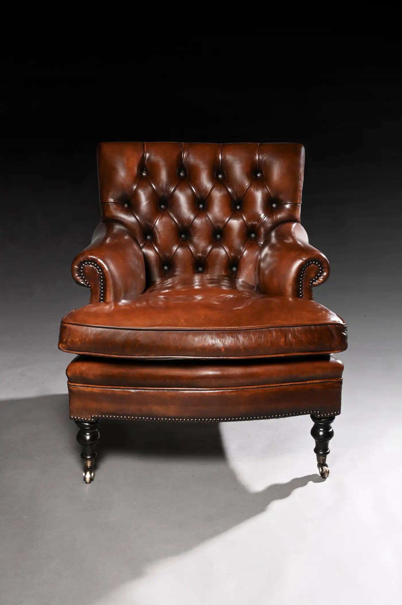 Brown leather armchair on a dark background