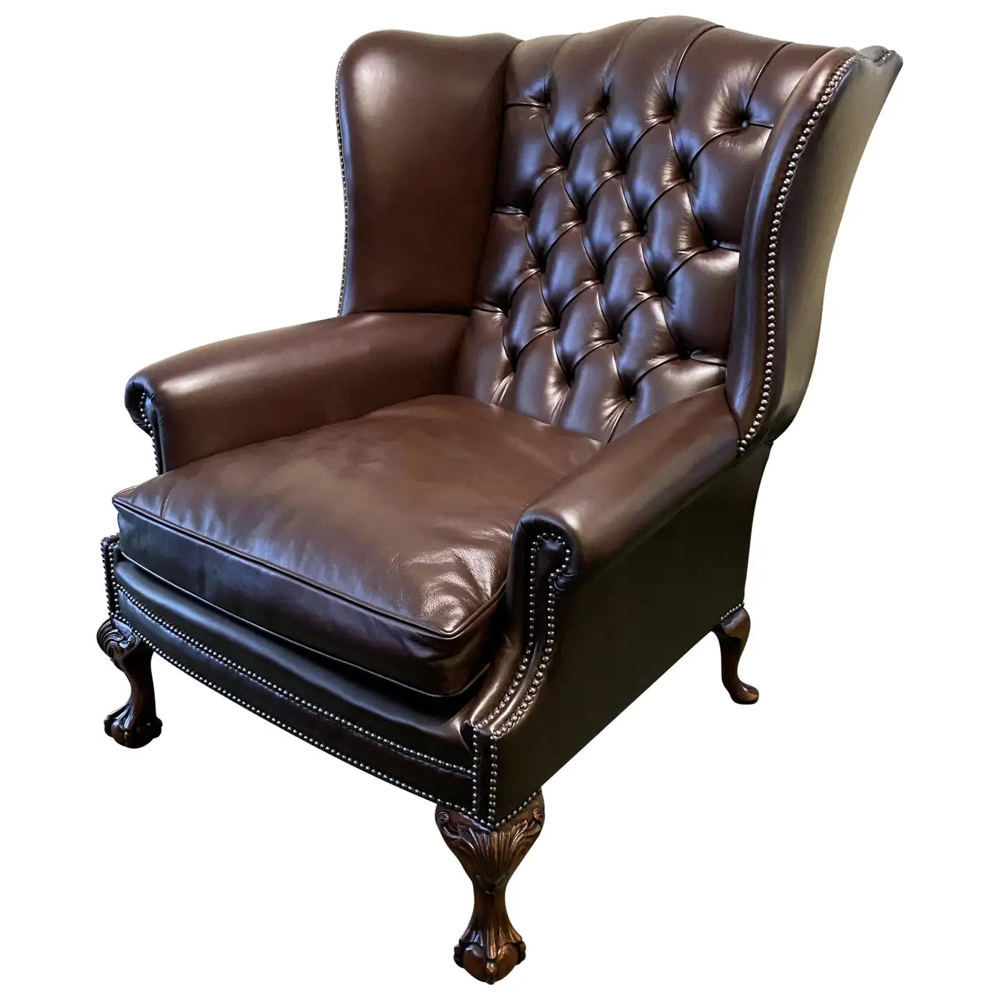 Brown leather armchair with tufted backrest on a white background