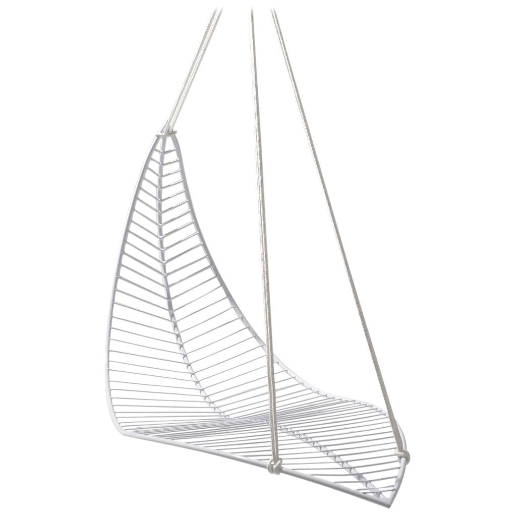 Wireframe chair hanging from a white background