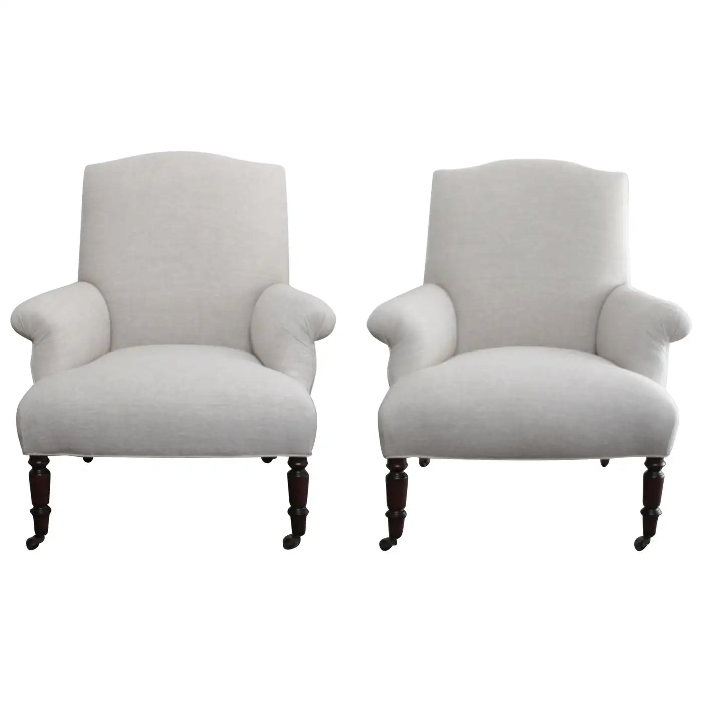 Two white armchairs with wooden legs on a white background