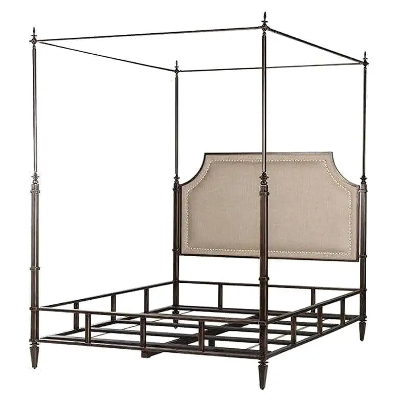 Canopy bed with metal frame and upholstered headboard on a white background