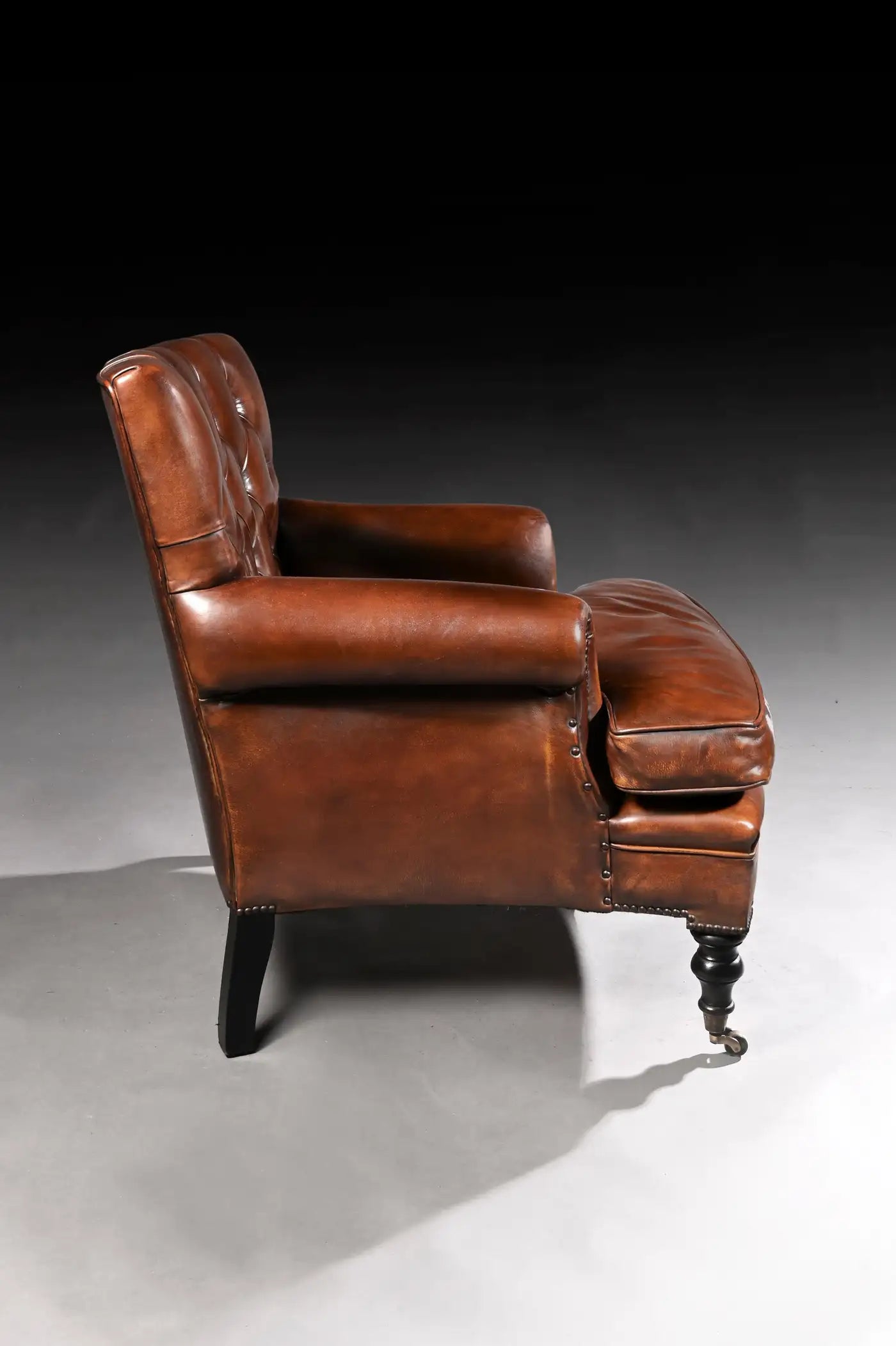 Brown leather armchair on a dark background
