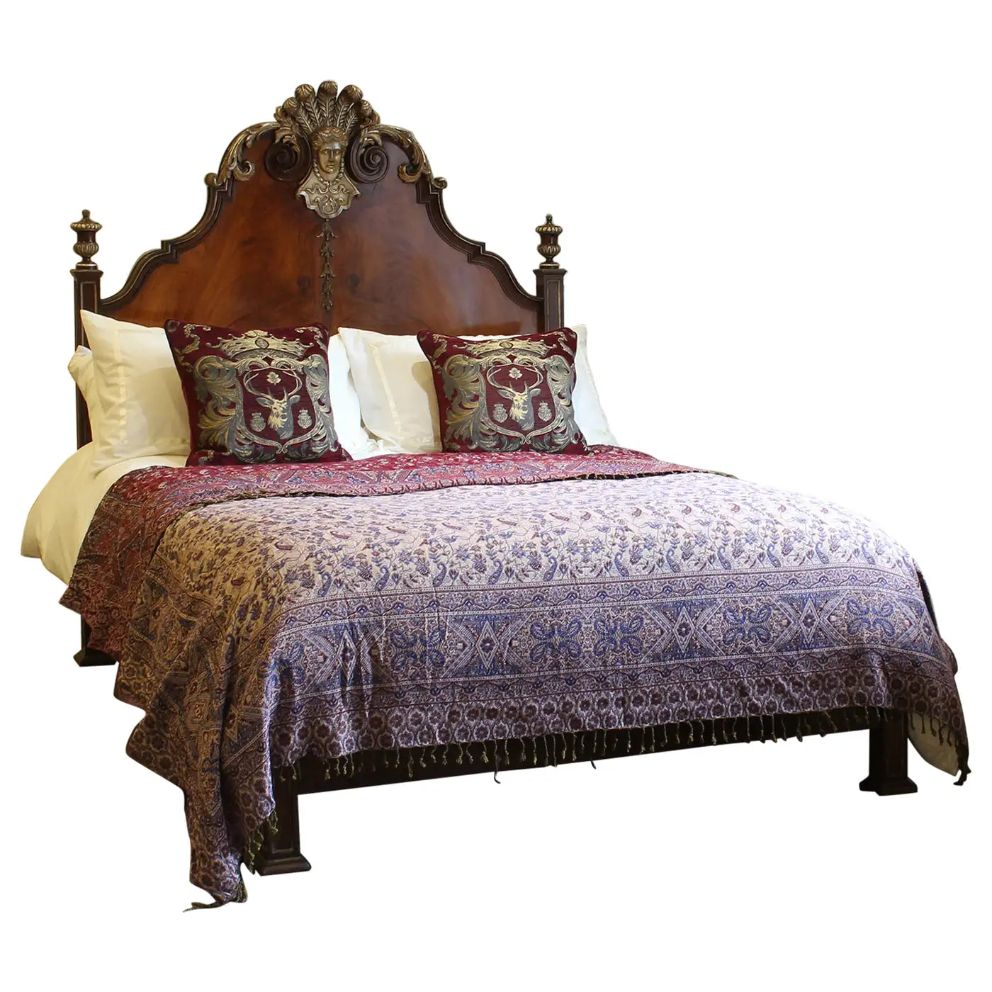 Decorative bed with patterned bedding and pillows on a white background