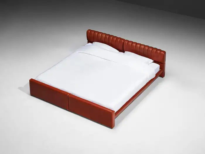 Red bed frame with white bedding on a gray background