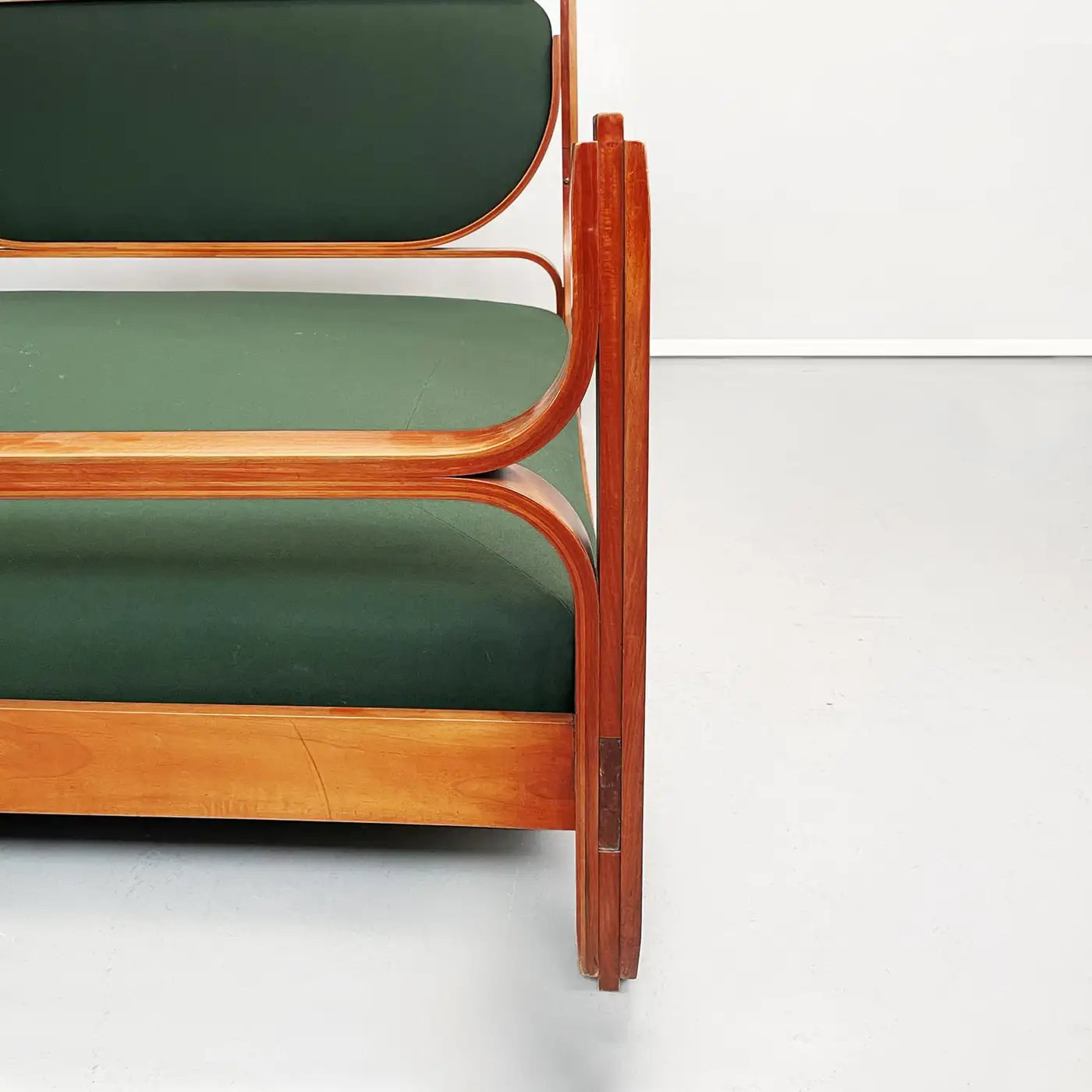 Wooden chair with green cushions on a white background