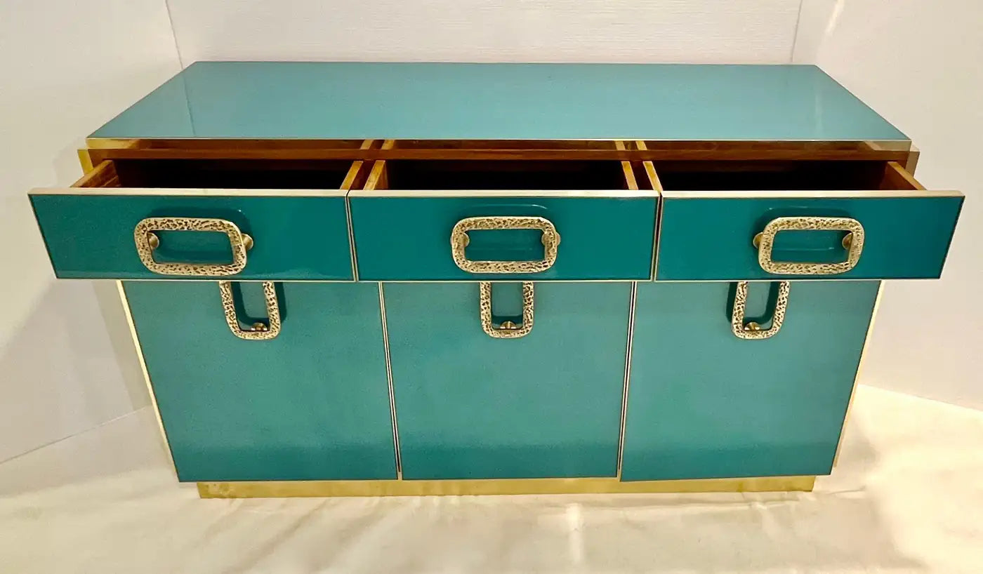 Teal storage trunk with gold accents on a white background