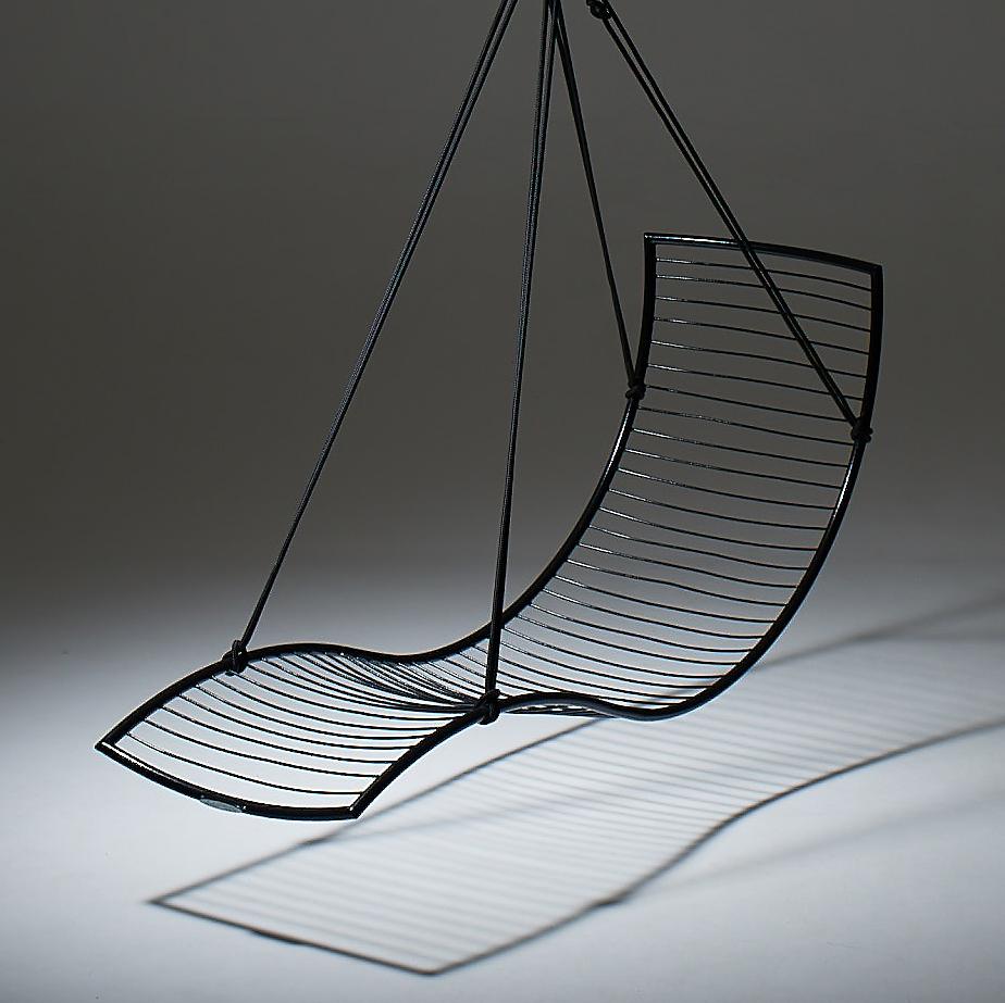 Black wire hanging chair on a gray background