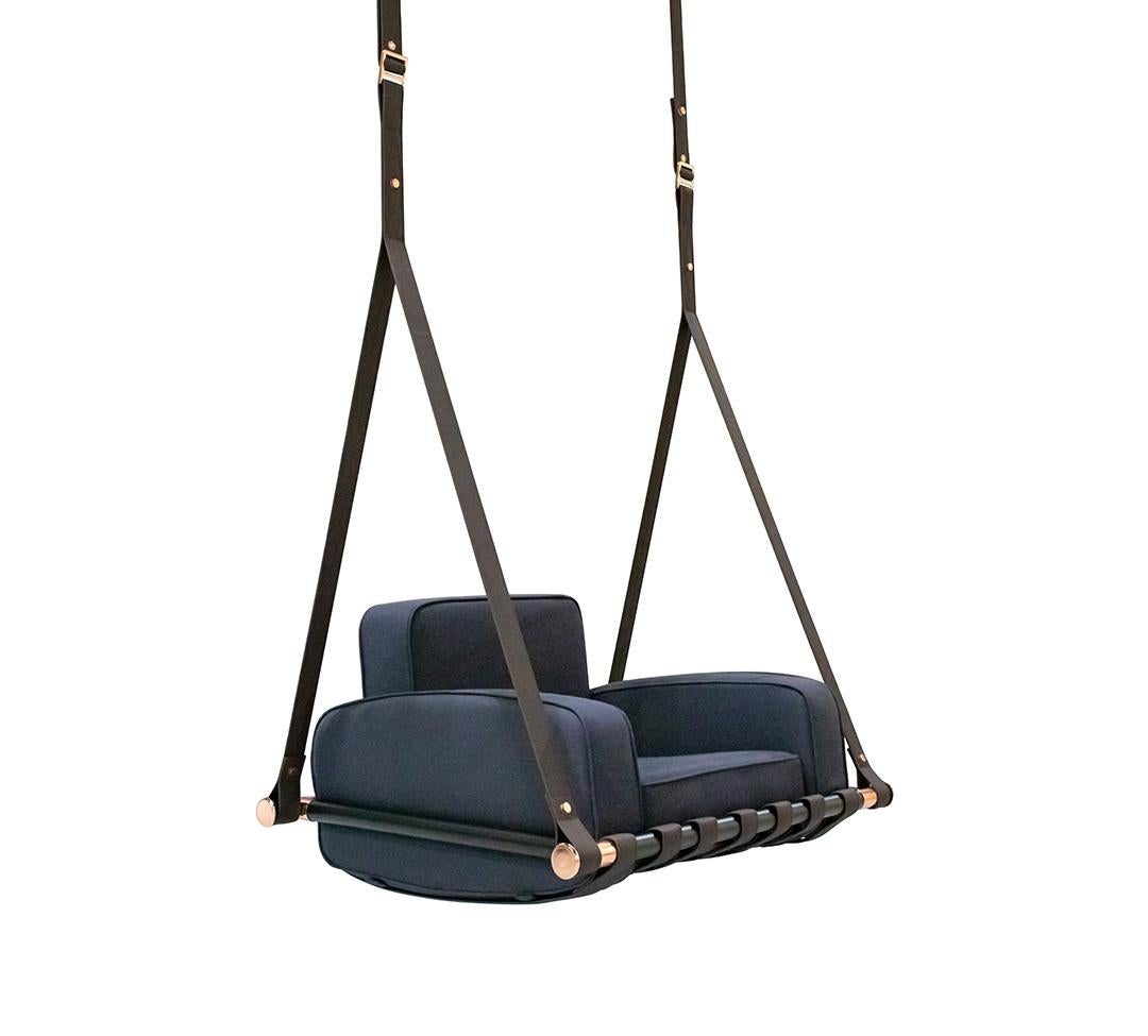 Blue swing chair with black straps on a white background