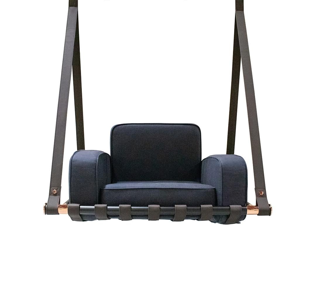 Blue cushioned swing with black straps on a white background