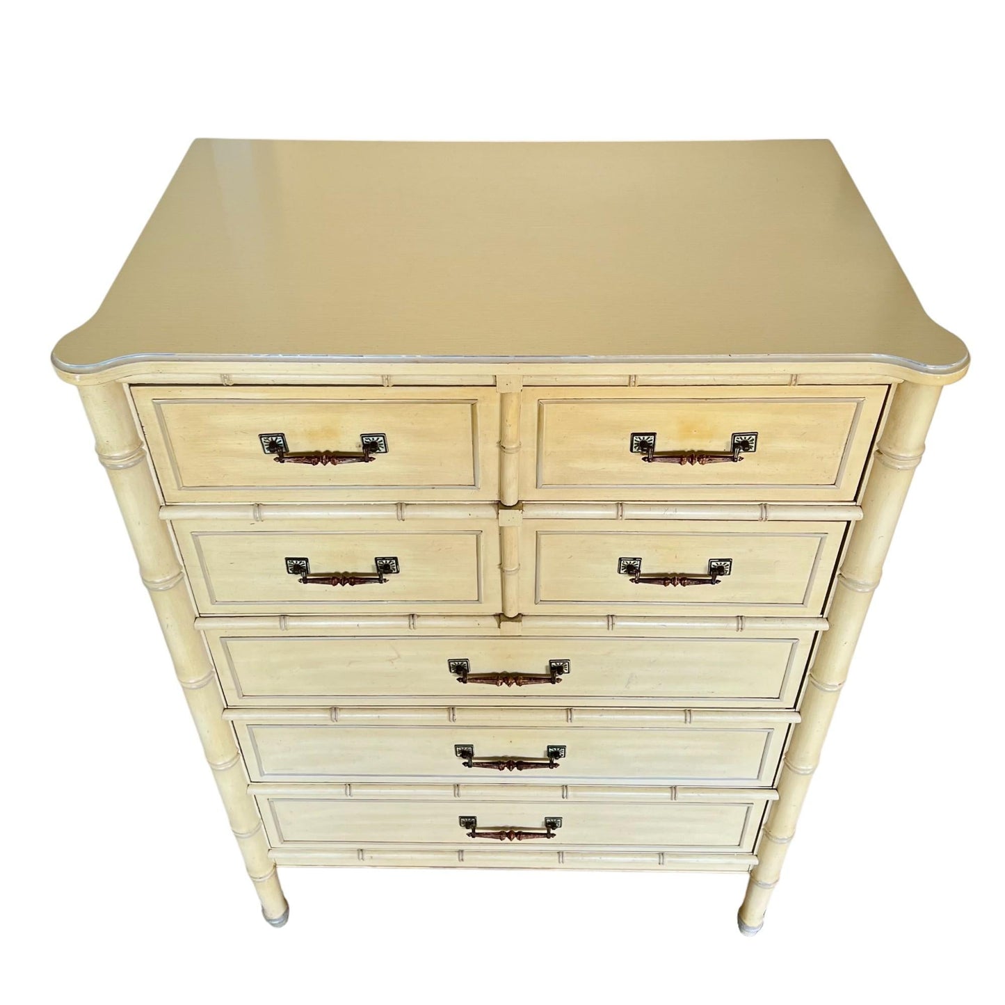 Beige dresser with multiple drawers on a white background