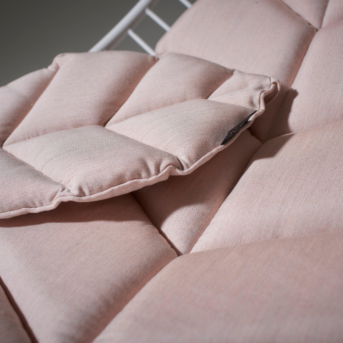 Close-up of a pink cushion with quilted pattern