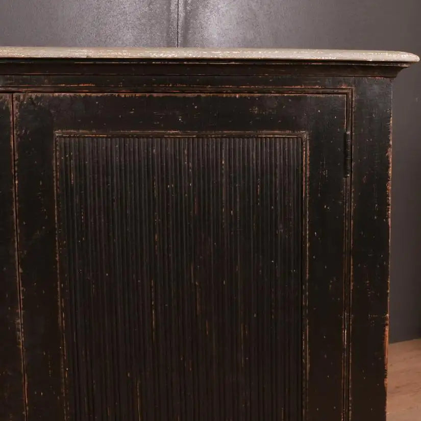 Dark wooden cabinet with a marble top against a dark background