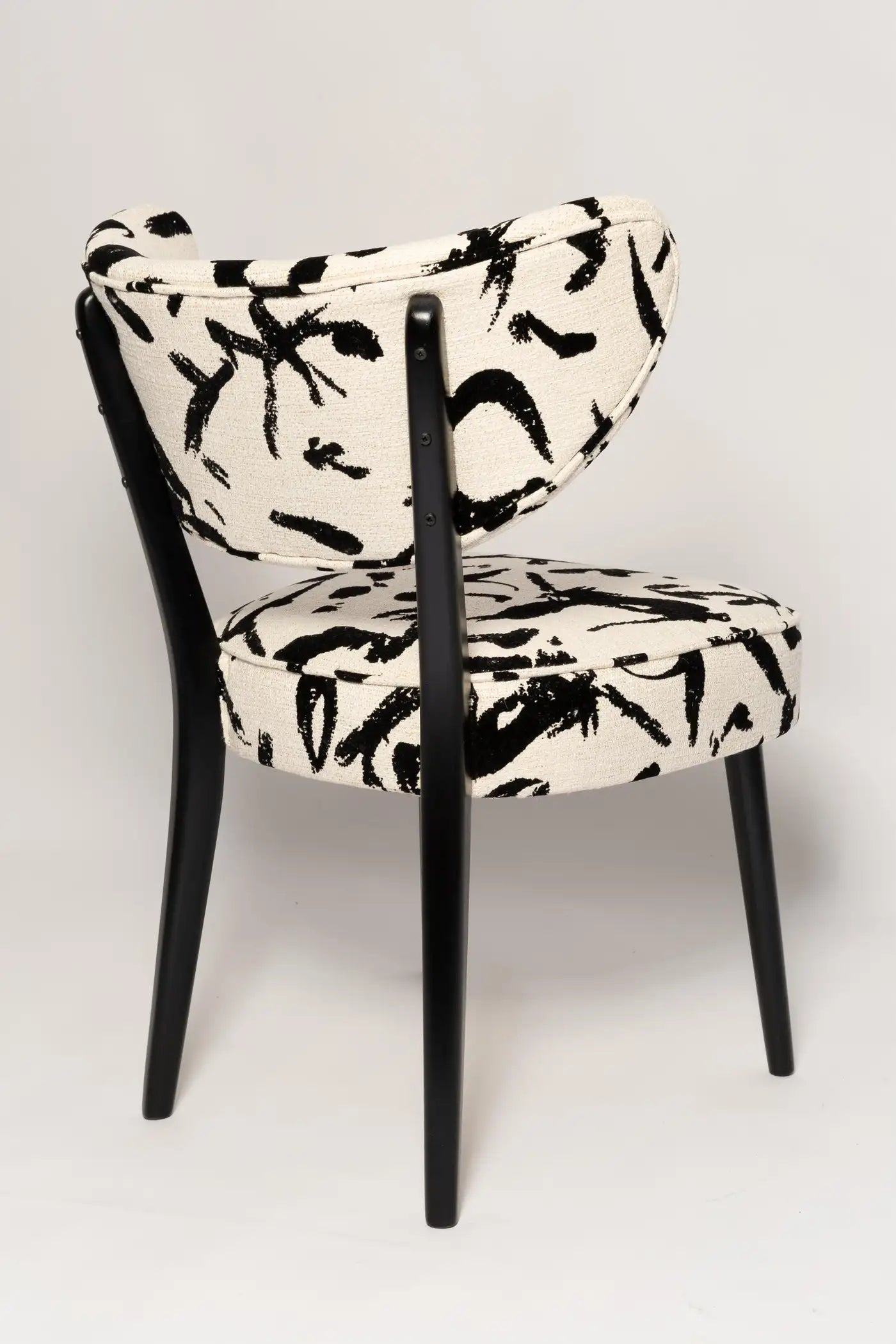 Chair with black and white abstract pattern on a light gray background