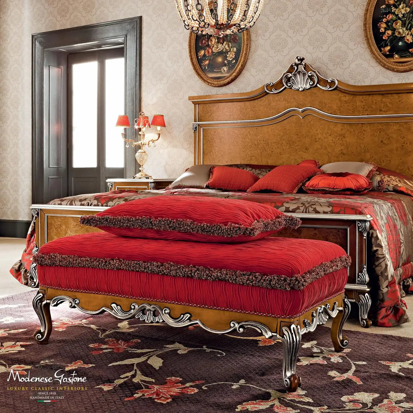 Luxurious bedroom with ornate bed and red bench, featuring Malmaison Furniture branding.