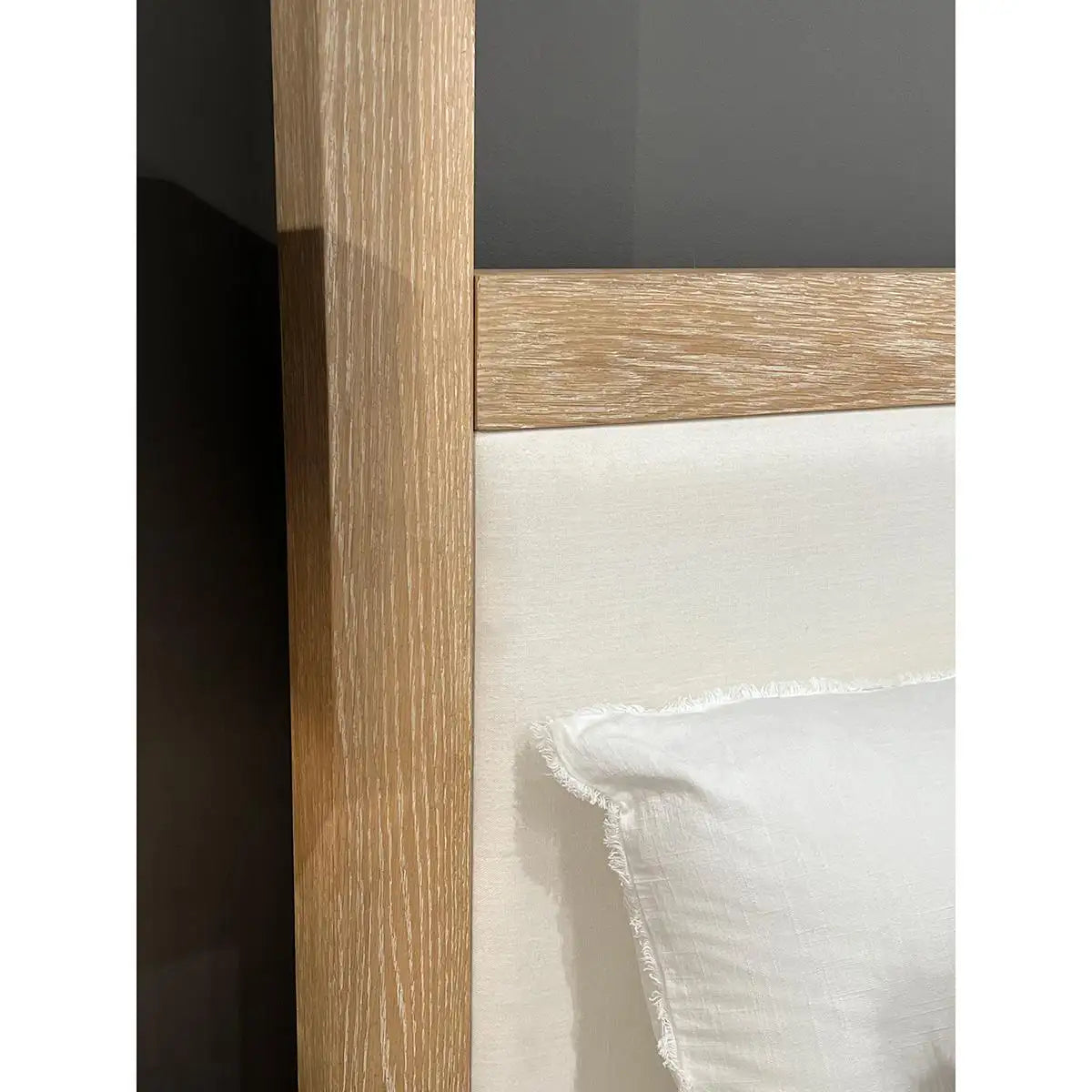 Close-up of a wooden cabinet with glass panel and white interior.