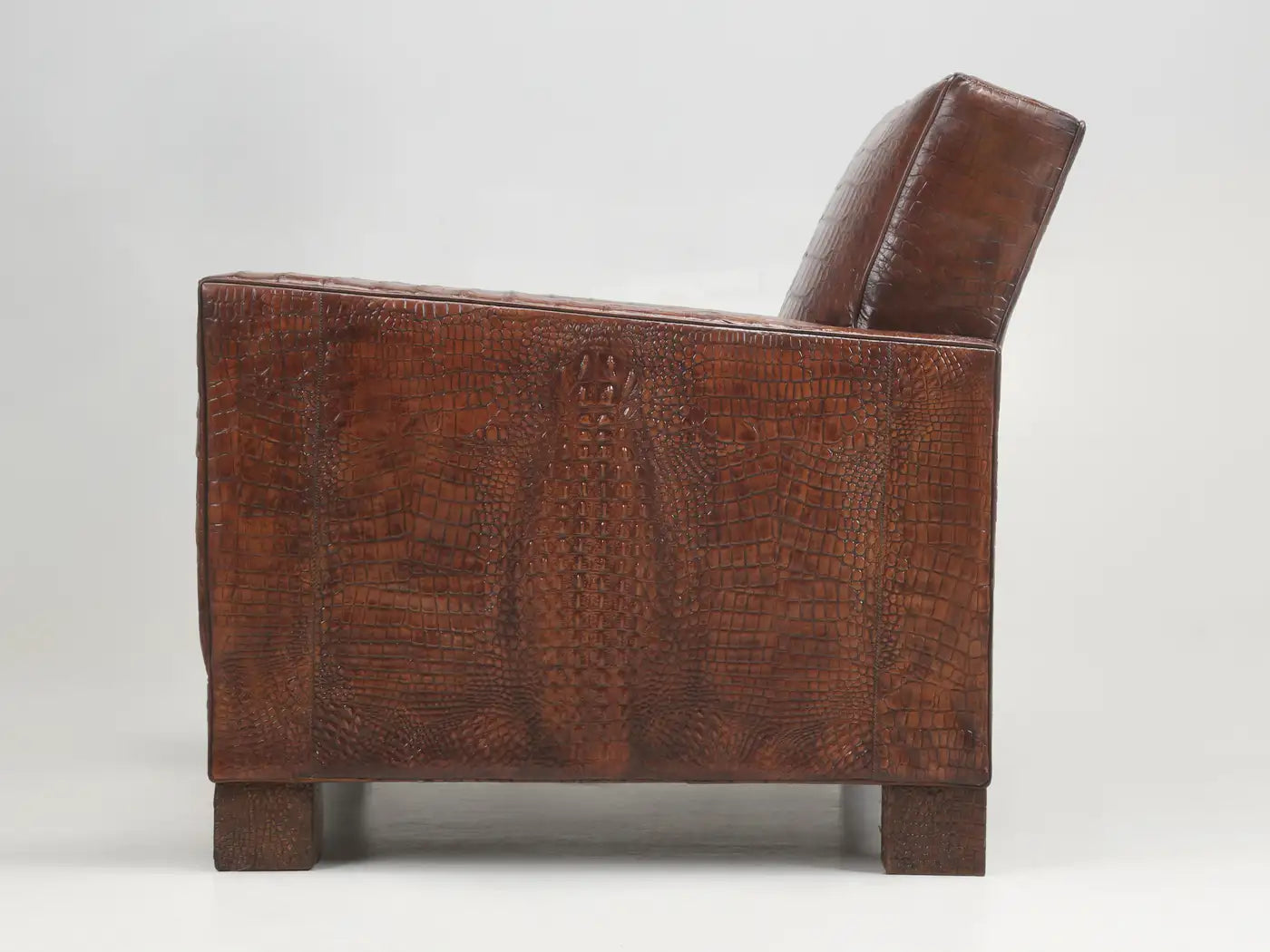 Brown leather armchair with a textured pattern on a white background