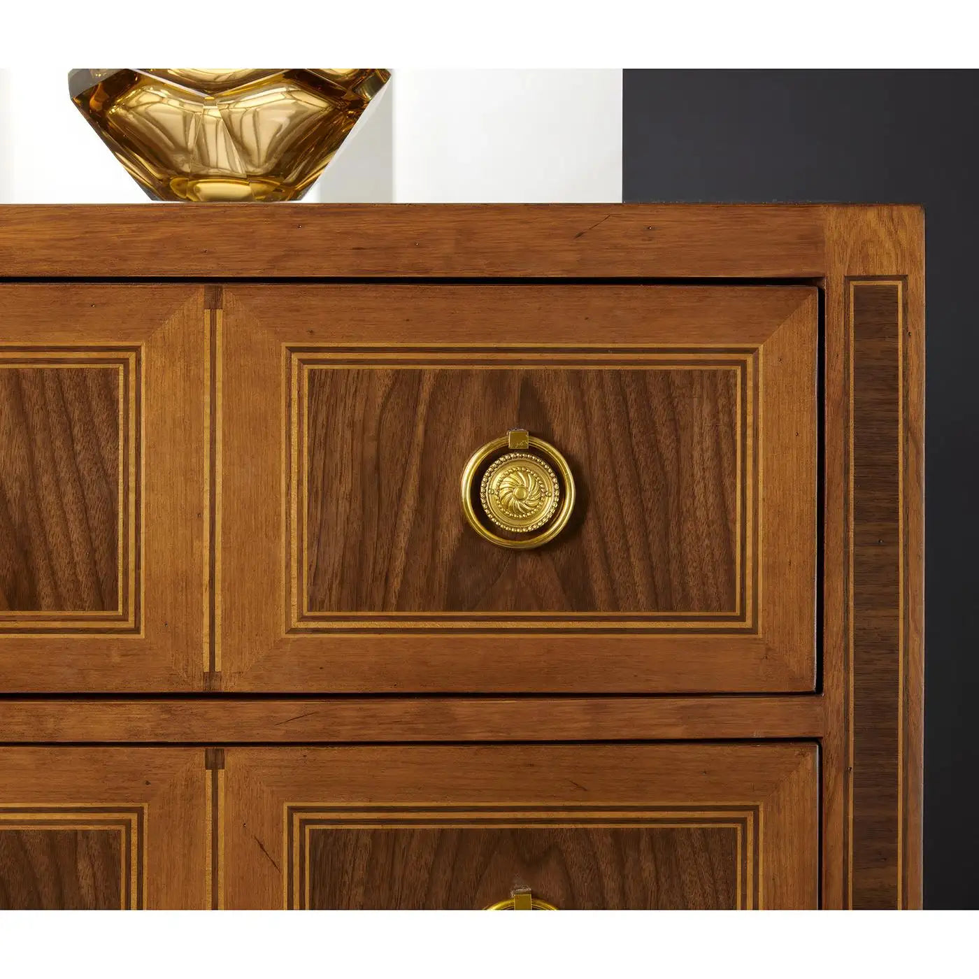 Wooden cabinet with decorative gold emblem on a white background