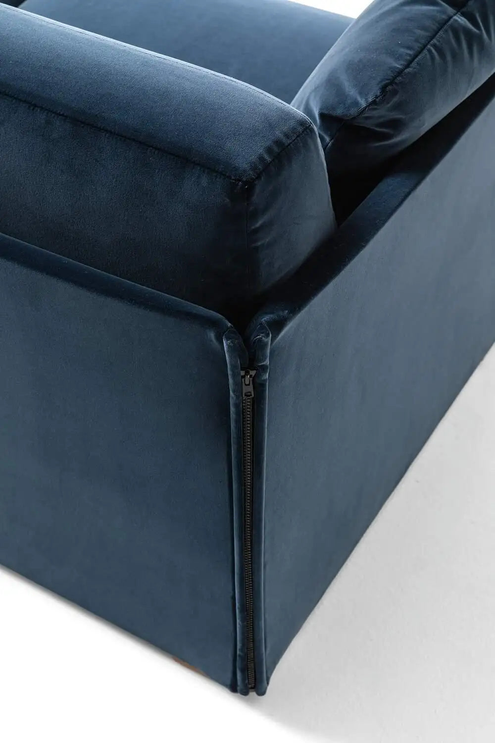 Navy blue sofa with a zipper detail on a white background