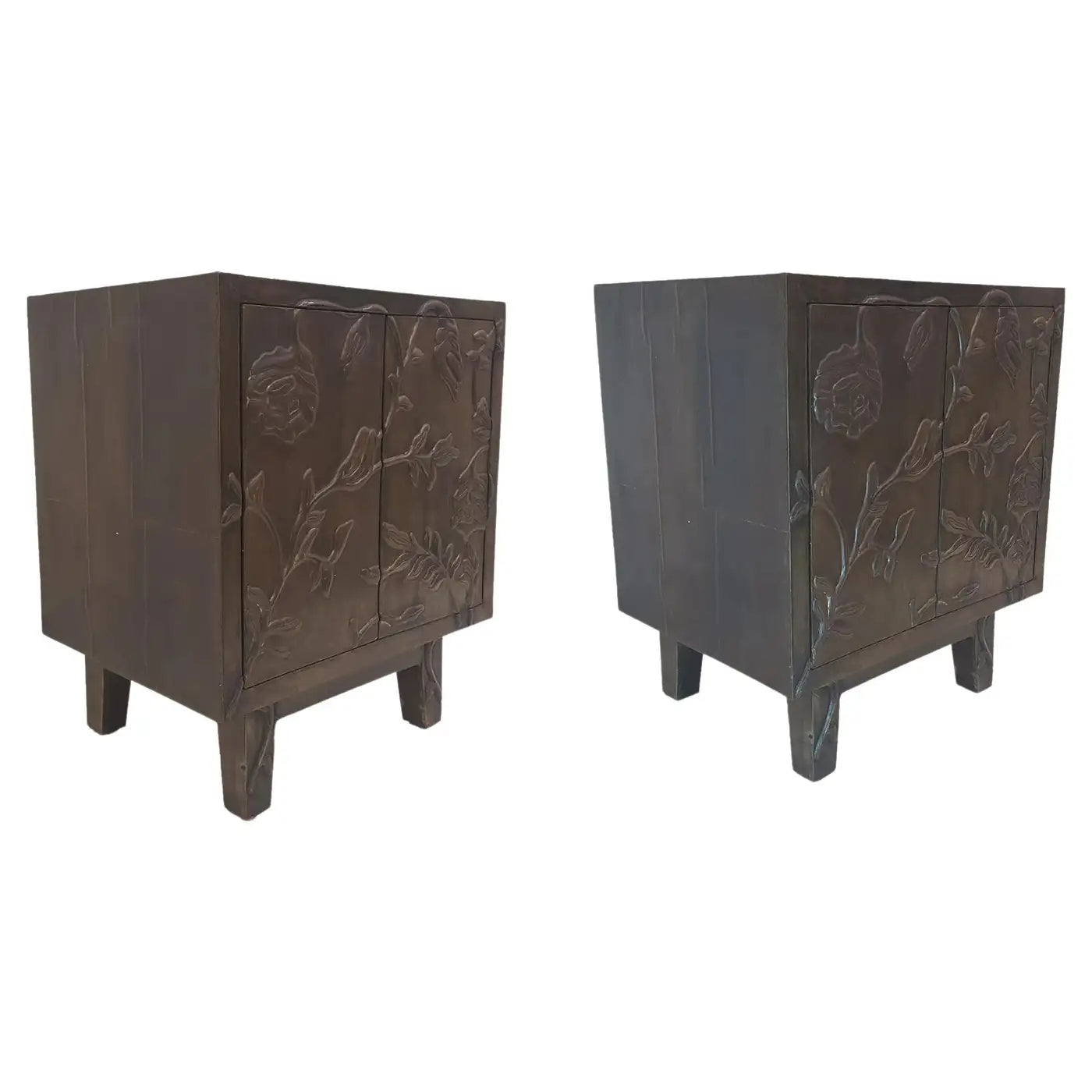 Two dark wooden cabinets with embossed designs on a white background
