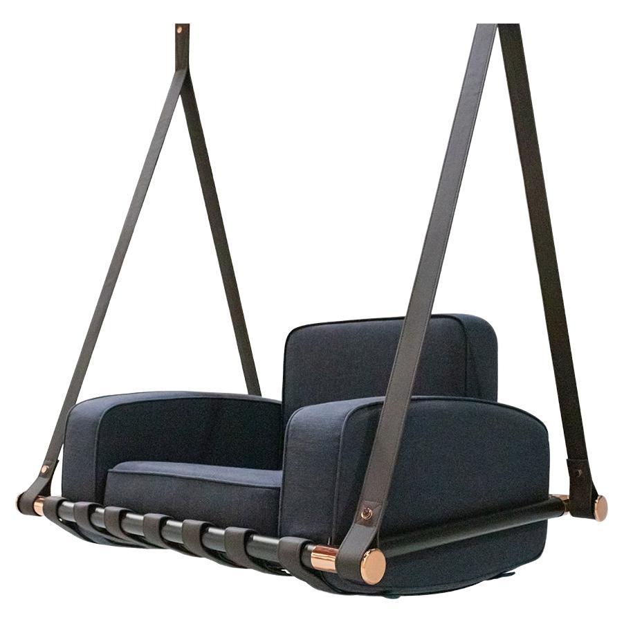 Blue swing chair with black straps on a white background