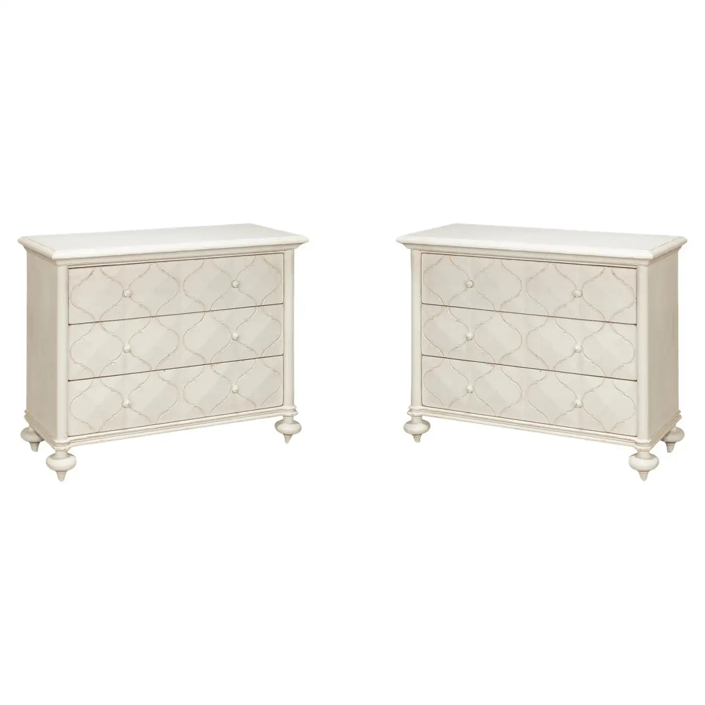 Two white dressers with decorative patterns on a white background