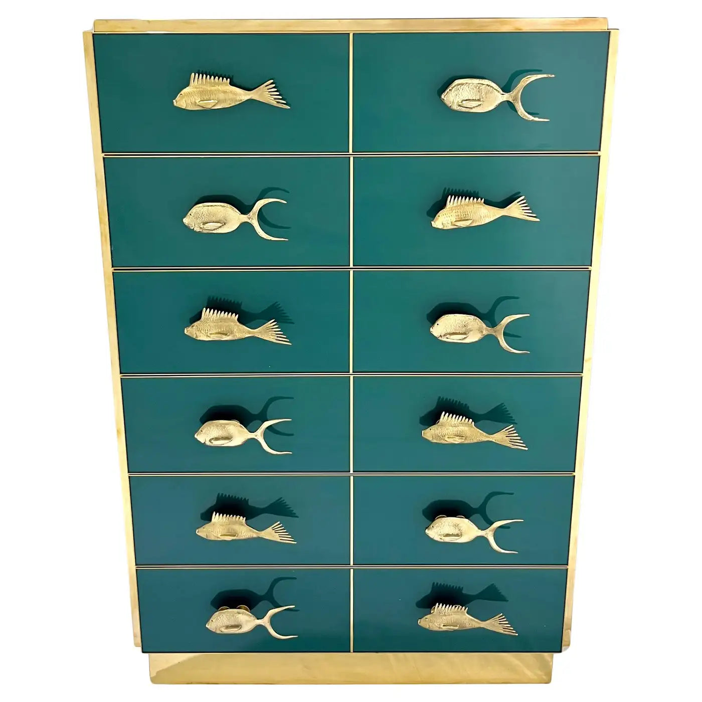 Teal dresser with gold fish-shaped handles on a white background
