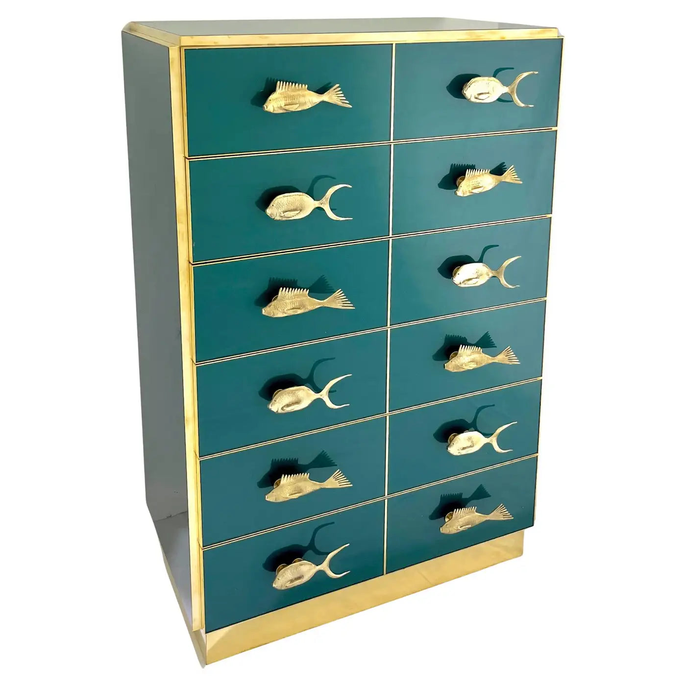 Teal dresser with gold fish-shaped handles on a white background