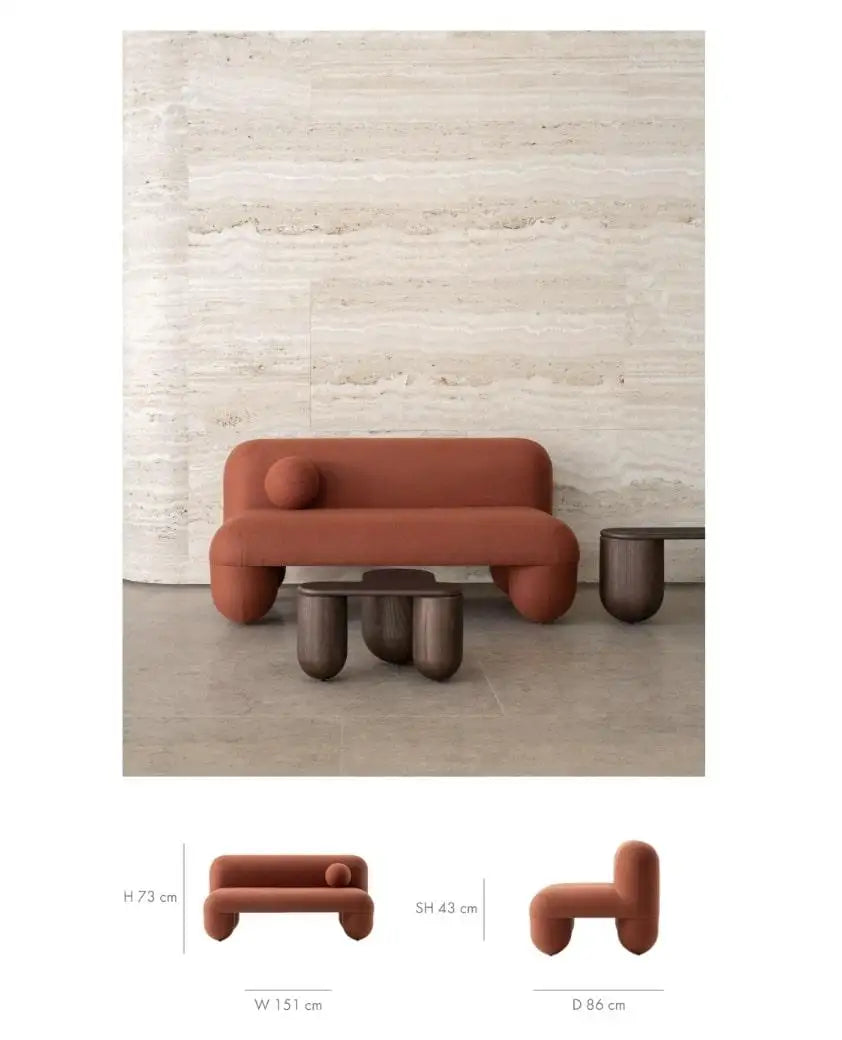 Modern brown sofa with matching coffee table against a textured wall.