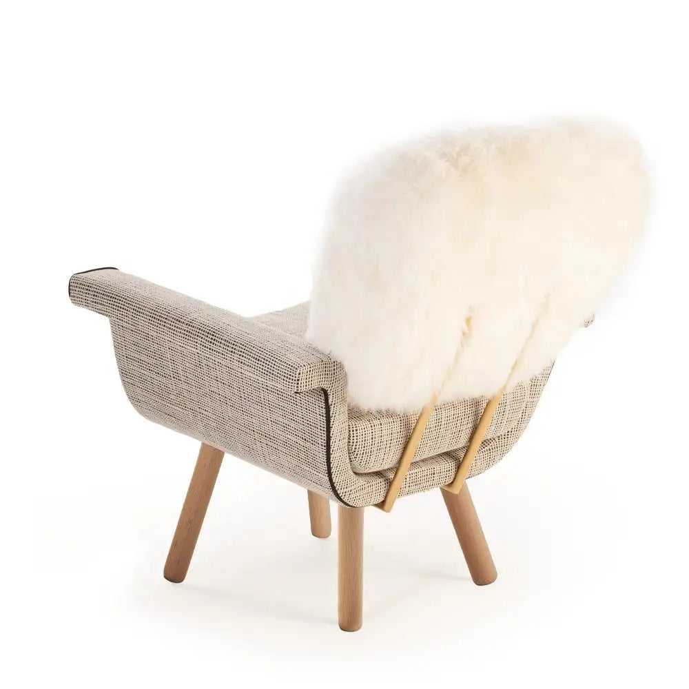 Chair with a textured backrest and wooden legs on a white background
