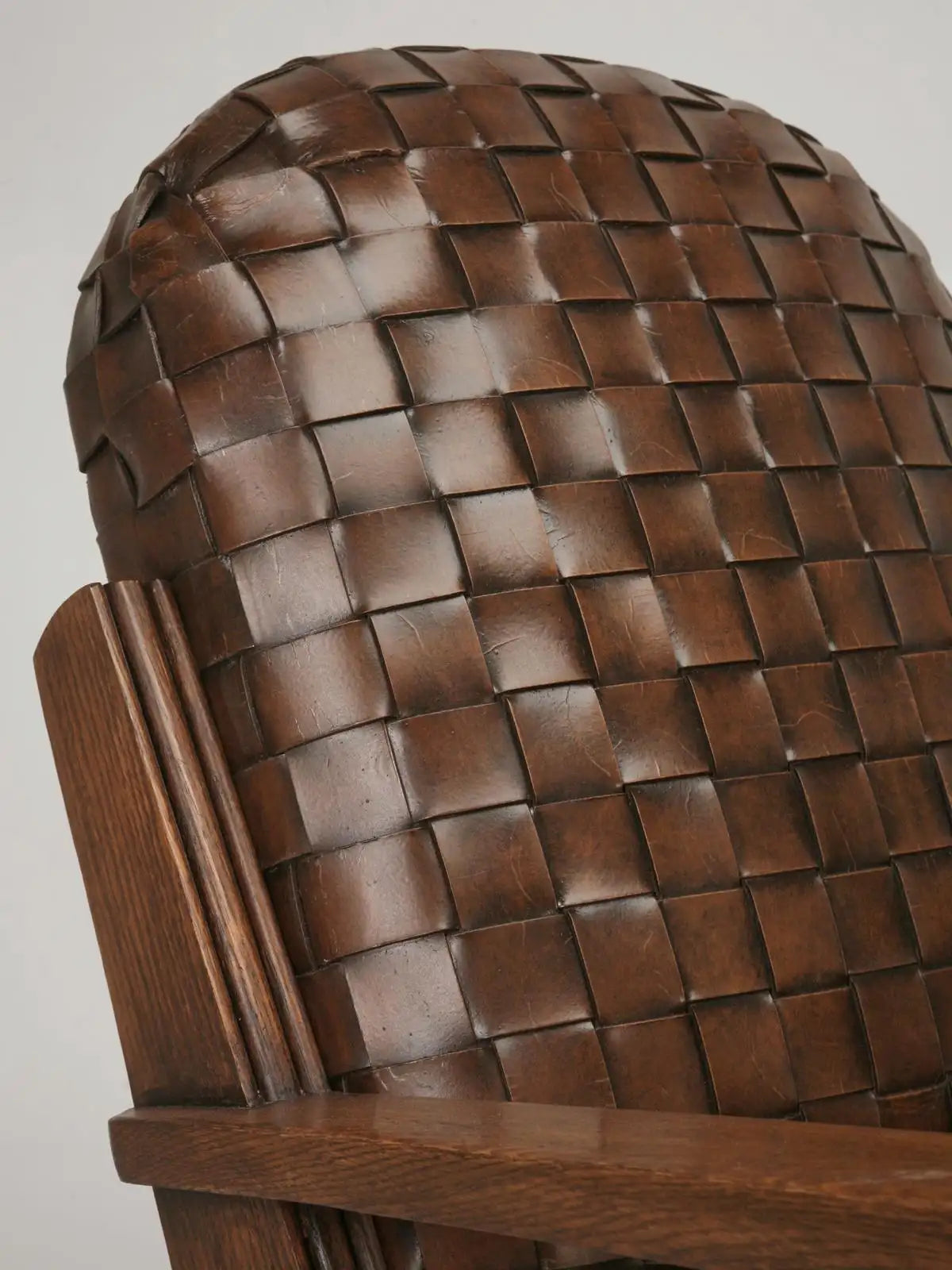 Wooden chair with woven backrest on a plain background