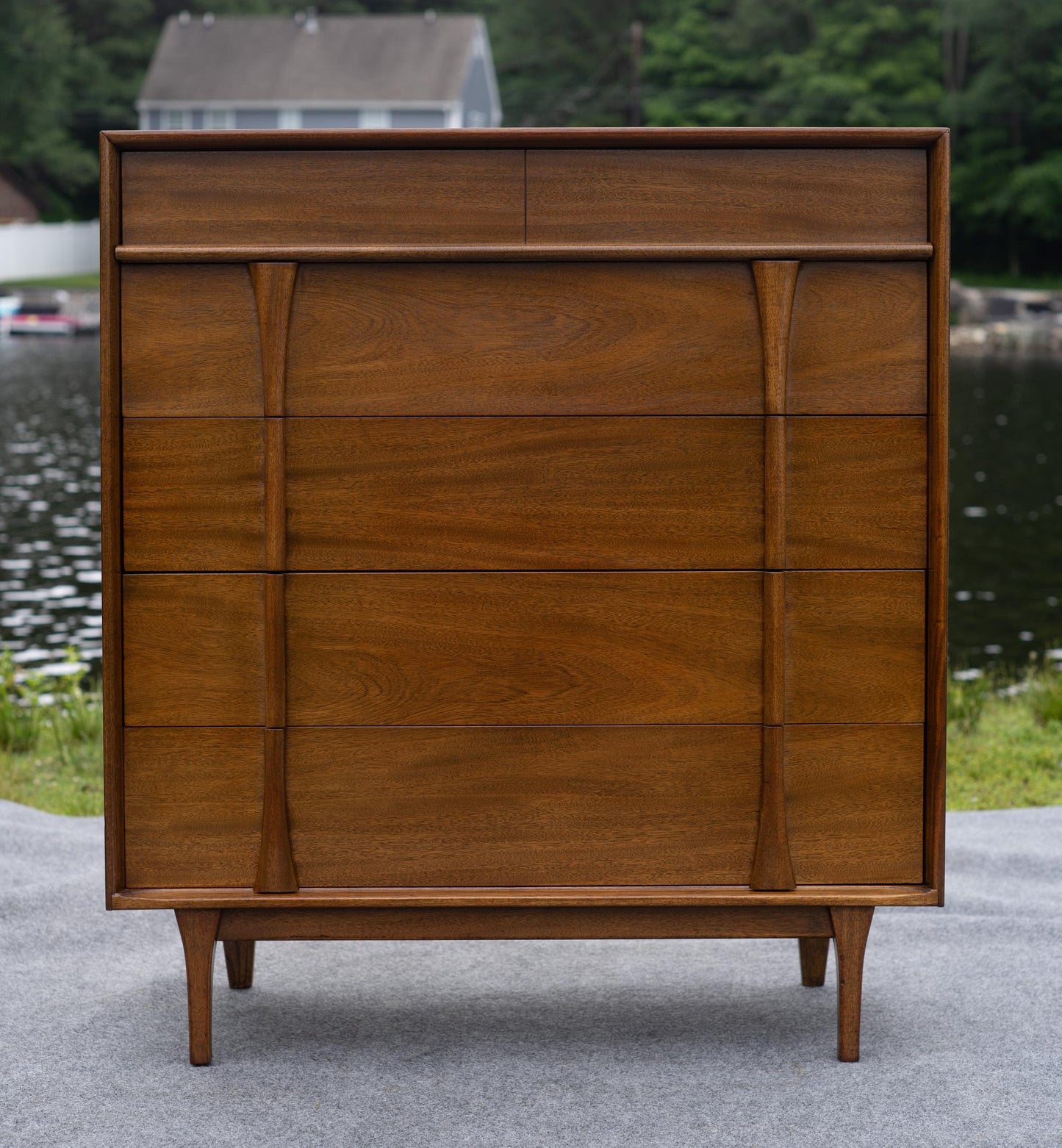 Wooden dresser with multiple drawers in an outdoor setting