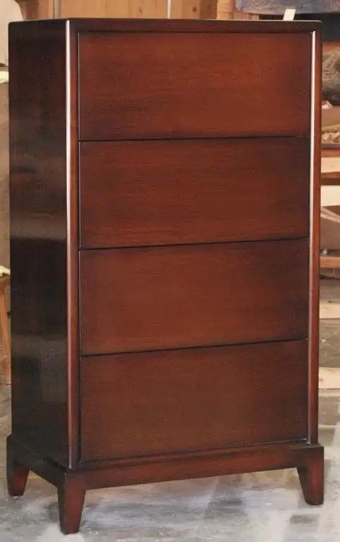 Wooden dresser with four drawers on a wooden floor.