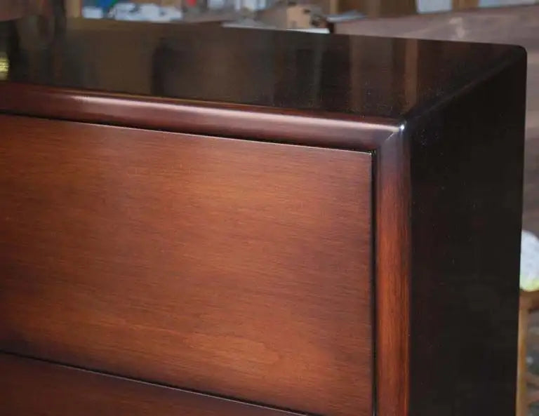 Close-up of a wooden drawer with a blurred background