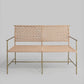 Woven bench with metal frame on a gray background