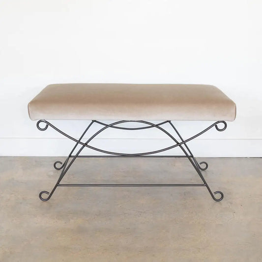 Bench with beige cushion and metal frame on a plain background