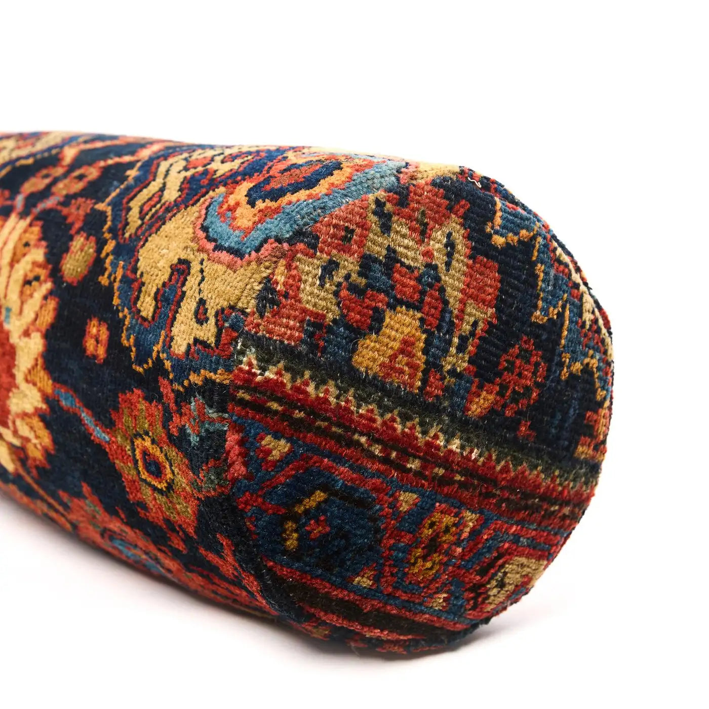 Decorative cylindrical pillow with intricate pattern on a white background
