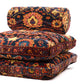 Stack of patterned cushions on a white background