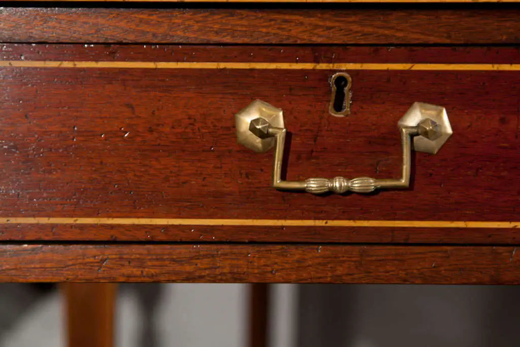 Wooden drawer with brass handle and keyhole