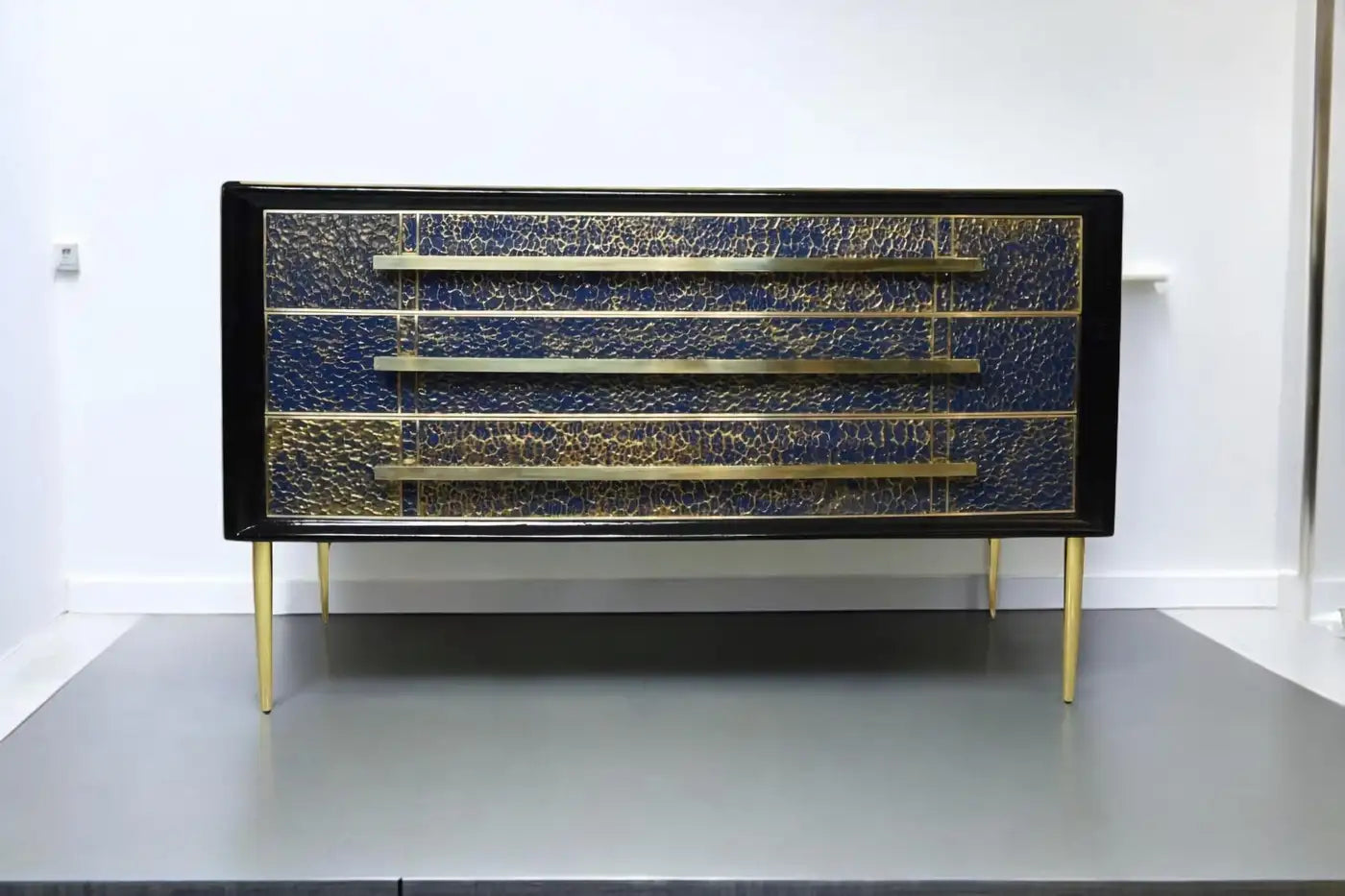Decorative cabinet with blue and gold pattern on a white background