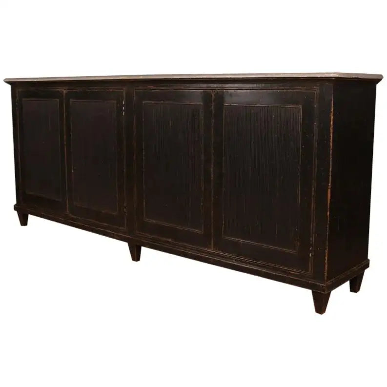 Dark wooden sideboard with four doors on a white background