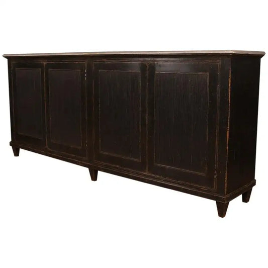 Dark wooden sideboard with four doors on a white background