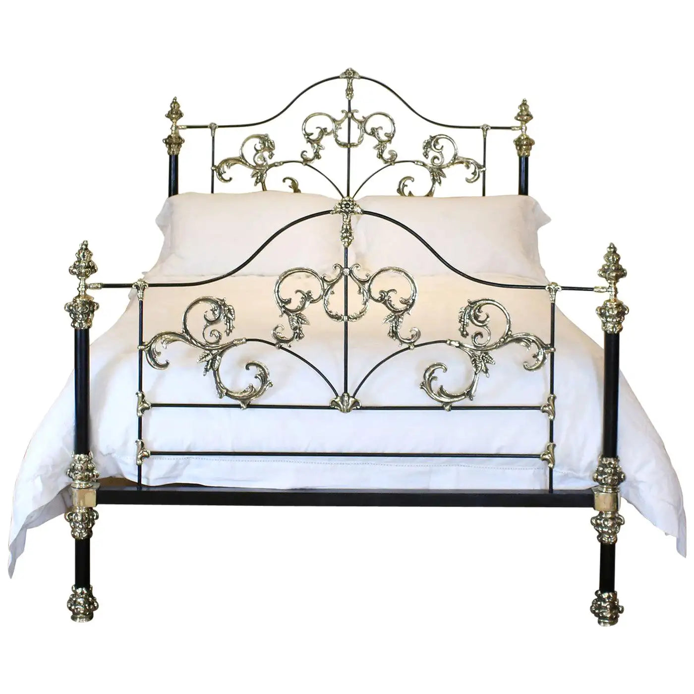 Decorative metal bed with intricate designs on a white background