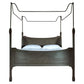 Wooden canopy bed with white bedding on a white background
