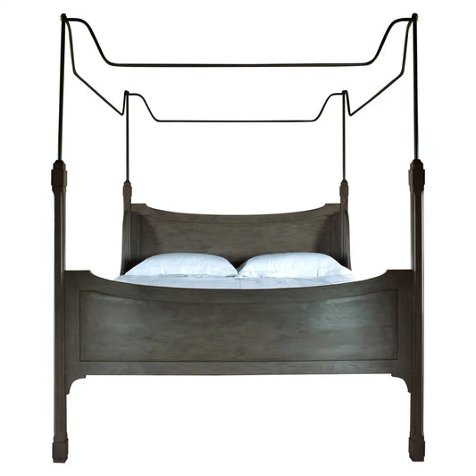 Wooden canopy bed with white bedding on a white background
